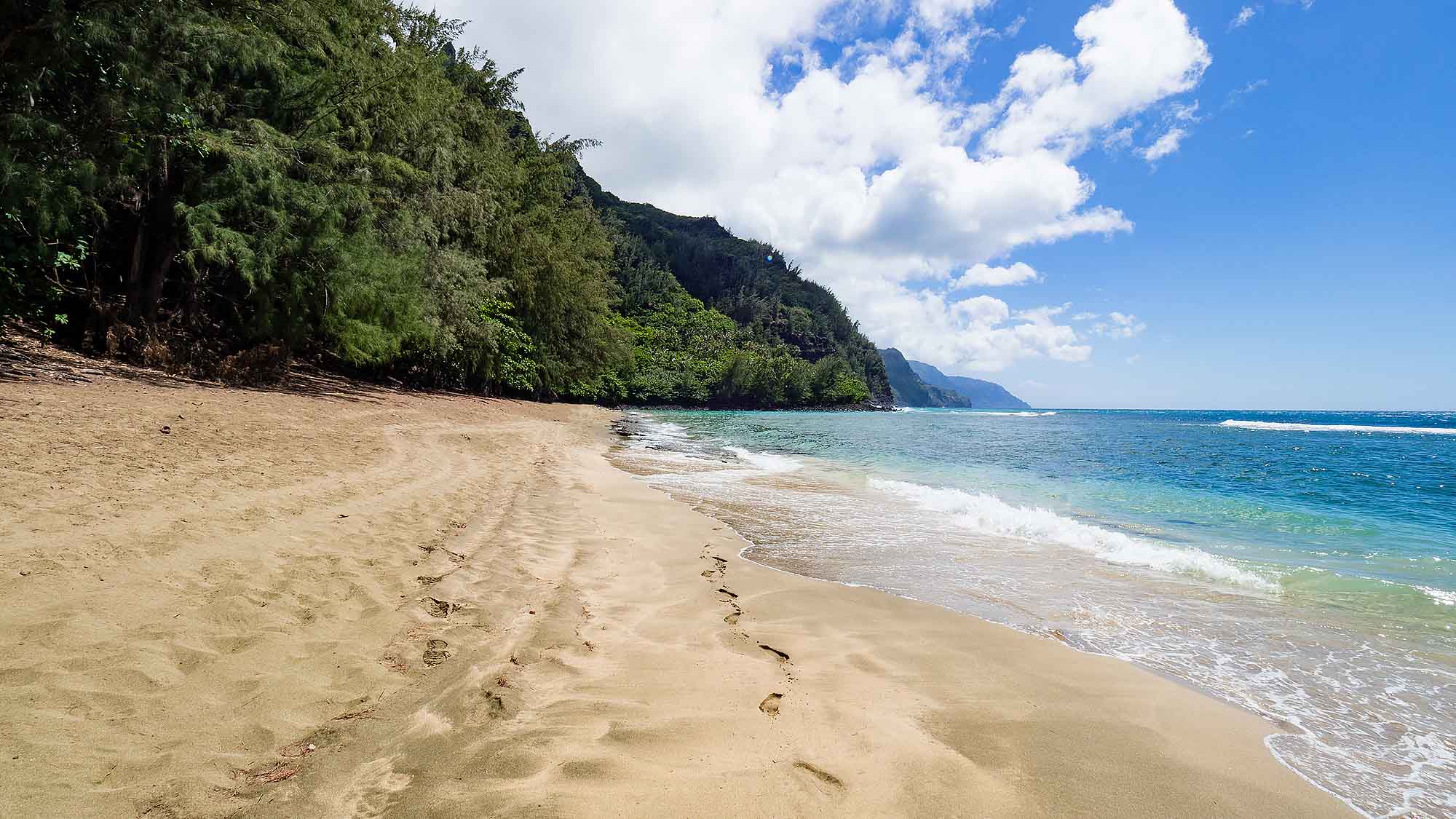 10 year old boy walking on Ke'e Beach, Kauai, Hawaii