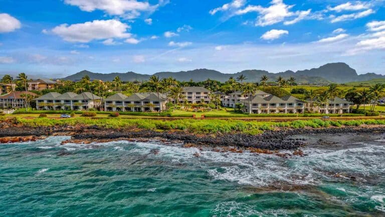 Oceanfront view of Poipu Kapili resort on Kauai’s South Shore featuring tropical grounds, spacious villas, and Pacific Ocean sunsets.