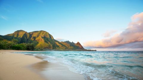 Walk a pristine beach with mountain views on a spring break to Kauai, Hawaii