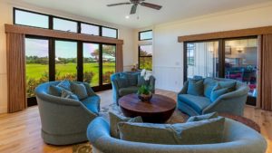 The living room in Kukuiula Makai Cottage #71 features comfy chairs and great views