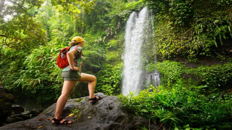 A woman hiking while practicing sustainable tourism in Hawaii