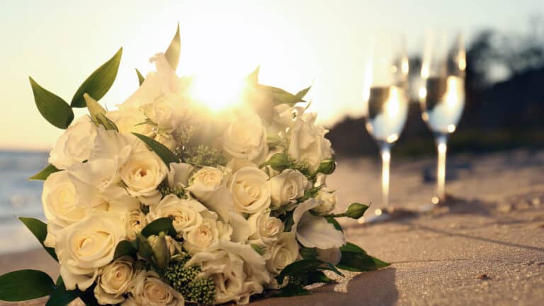 Flowers and champagne on a beach in Kauai for a couple celebrating their honeymoon