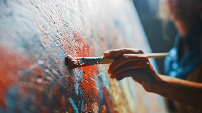 An artist painting at Warehouse 3540, an indoor market on Kauai