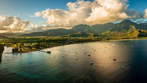 A peaceful Hanalei Bay with lush mountains in the background