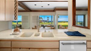 The kitchen with a view out the the well-kept grounds at Poipu Sands at Poipu Kai #514