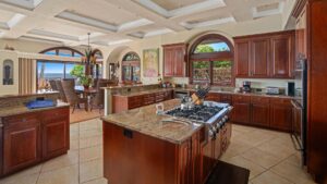 The spacious kitchen that blends into the dining room in one of Parrish Kauai's vacation rentals for large groups