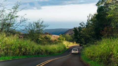 A car driving around a back road in Kauai