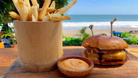 A burger and fries on a beach in Kauai