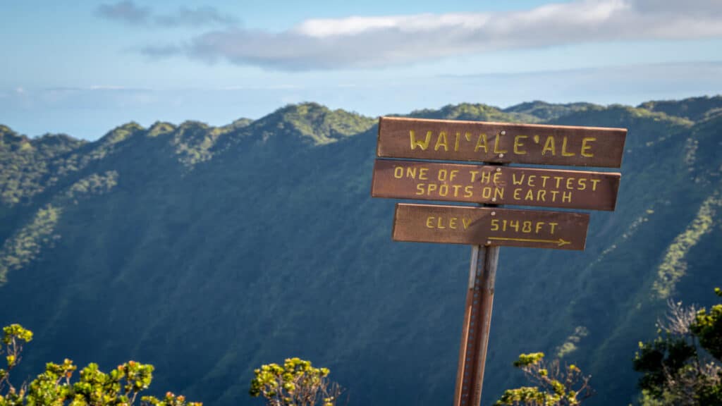 A sign at the top of Mount Waialeale in Kauai, declaring it as one of the wettest place on Earth