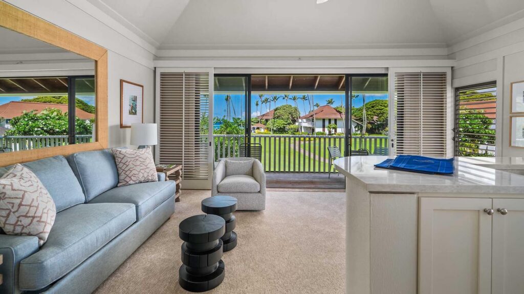 The living room with comfortable seating and countertop with a view of the ocean at Kiahuna Plantation #029