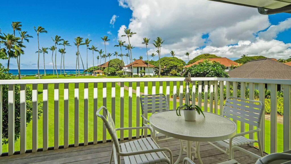 An ocean view off the covered lanai with a table and chairs at Kiahuna Plantation #029
